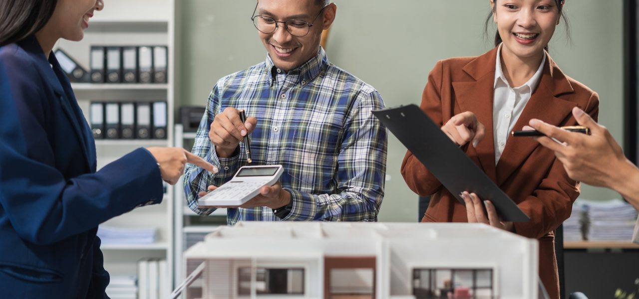 Engineer teams meeting working together wear worker helmets hardhat on construction site. Asian industry professional team.